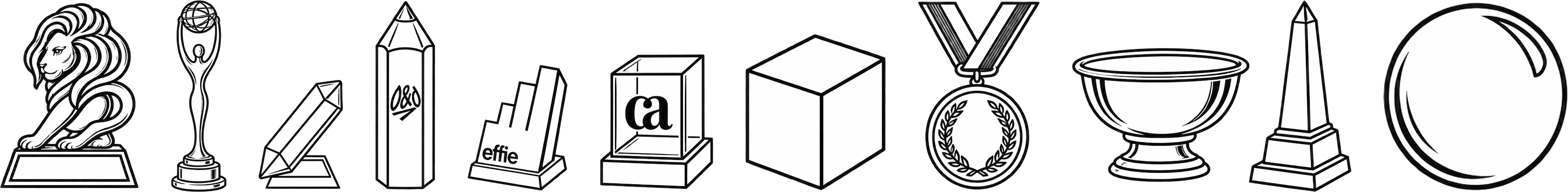 Engraved award trophies in a row: a lion, a statuette, a pencil, a cube, a medal, a bowl, an obelisk, a sphere